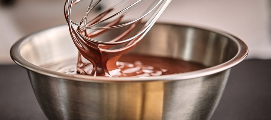 mixing bowl, whisk, melted chocolate